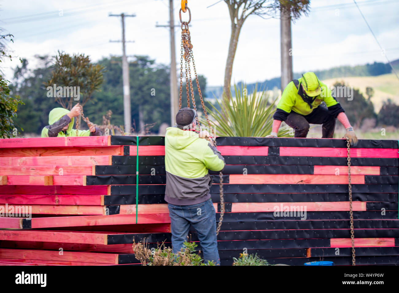 Sheffield. Canterbury, Nuova Zelanda, 25 Luglio 2019: costruttori scaricare capriate che sono stati consegnati da un carrello Hiab ad un sito di costruzione Foto Stock