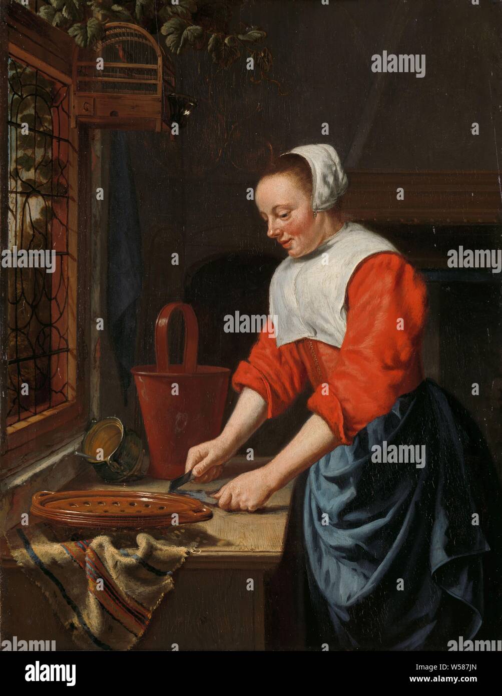 Il servo ragazza, serva. In una cucina, una cameriera è qualcosa di taglio o di pulizia su un tavolo da una finestra. Sul tavolo sono uno scolapasta, una pentola e un cucchiaio. Al di sopra della finestra è una gabbia di uccelli, cucina cameriera, cucina servo, cucina interno, Willem van Odekercken (attribuito a), 1631 - 1677, pannello, pittura a olio (vernice), h 31 cm × W 24 cm d 6 cm Foto Stock