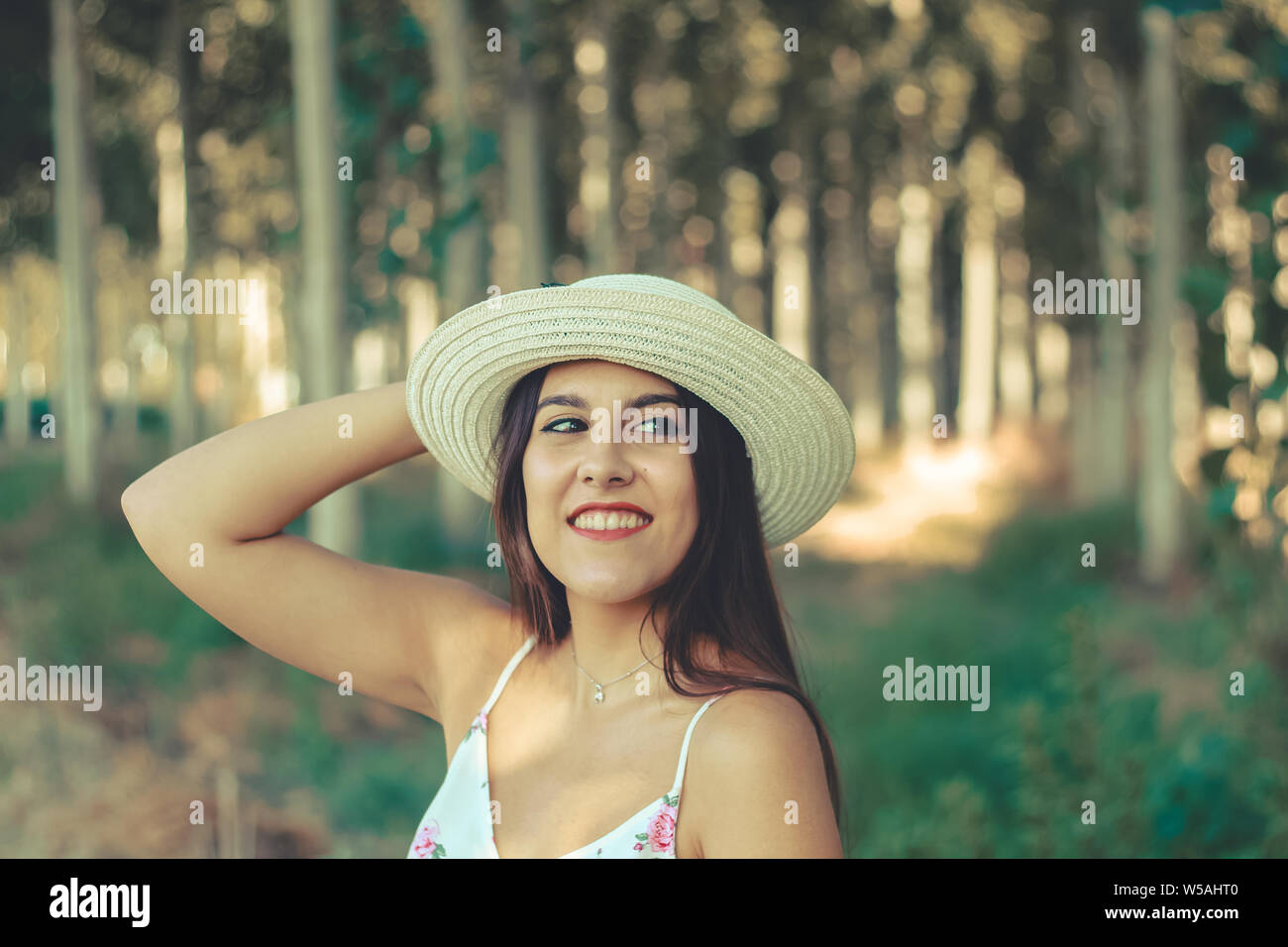 Ritratto os un sorridente bella bruna ragazza indossando un cappello per il sole Foto Stock