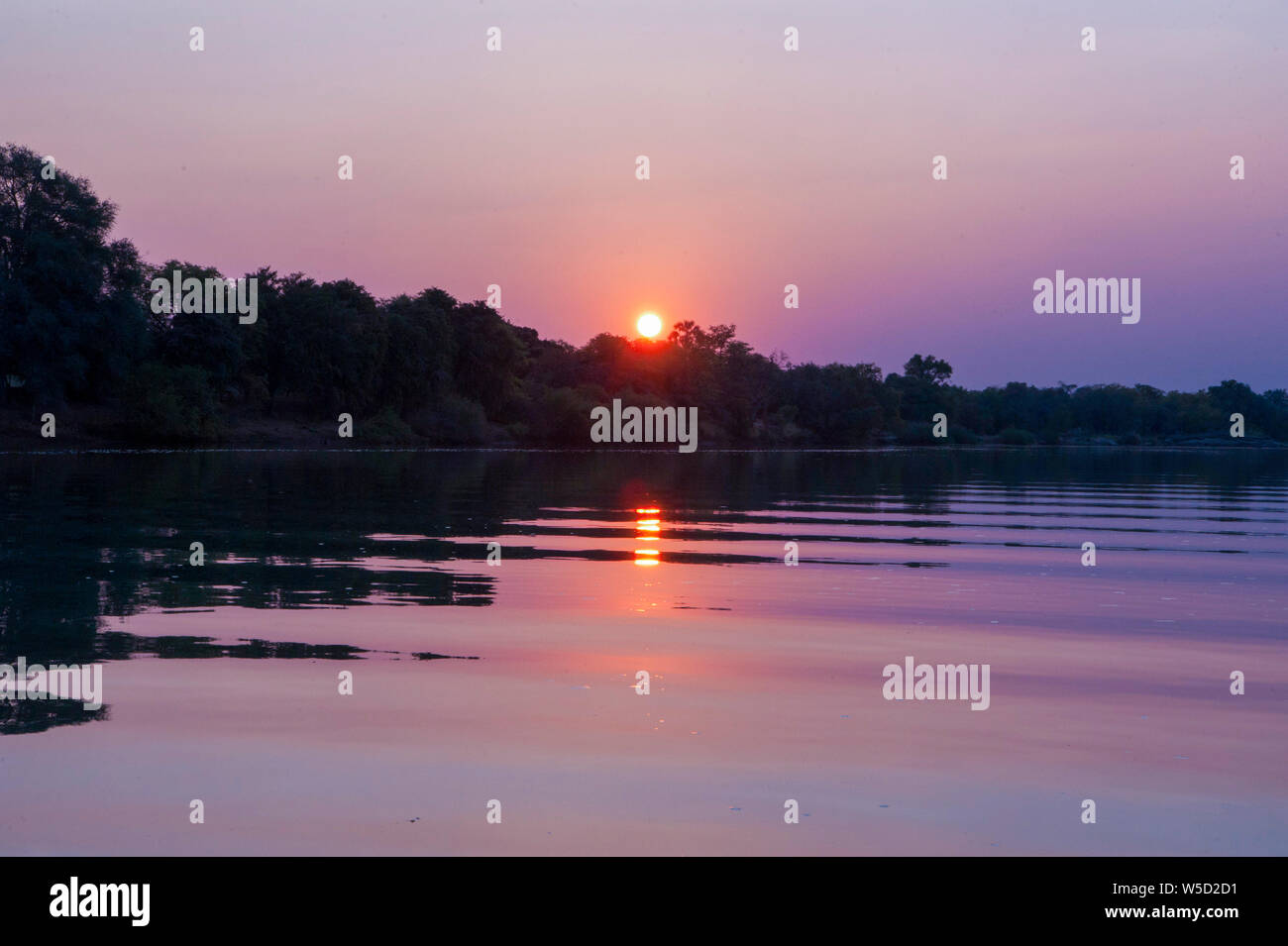 Tramonto sul fiume Kunene Cunene (Fiume), il confine tra Angola e Namibia, Sud-ovest Africa Foto Stock