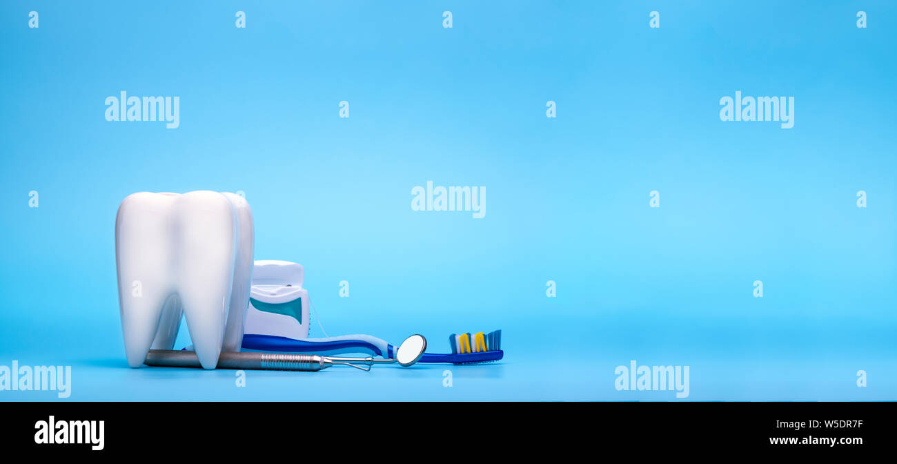 Bianco dente sano, diversi strumenti del dentista per cure dentarie. Banner dentale o sfondo.- Immagine Foto Stock