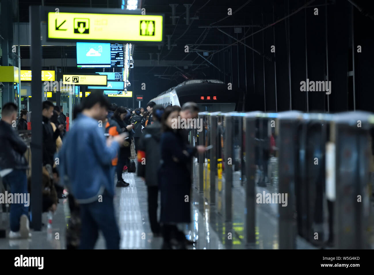 I passeggeri di attendere per il treno della metropolitana presso la stazione di Haitangxi sulla linea Loop di Chongqing Rail Transit in notturna a Chongqing Cina, 11 marzo 2019. Foto Stock