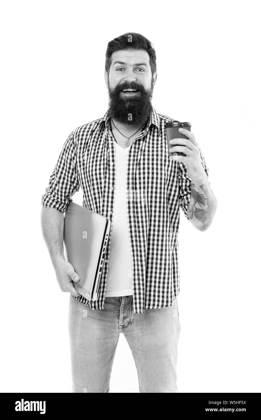 Il caffè fresco appena per me. Uomo Barbuto godendo il suo caffè di andare e mobile internet. Felice hipster tenendo chiuso portatile e la tazza di caffè. Il caffè mi sveglia al mattino. Foto Stock