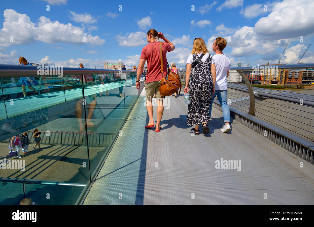 Londra, Inghilterra, Regno Unito. Turisti attraversando il Millennium Bridge Foto Stock