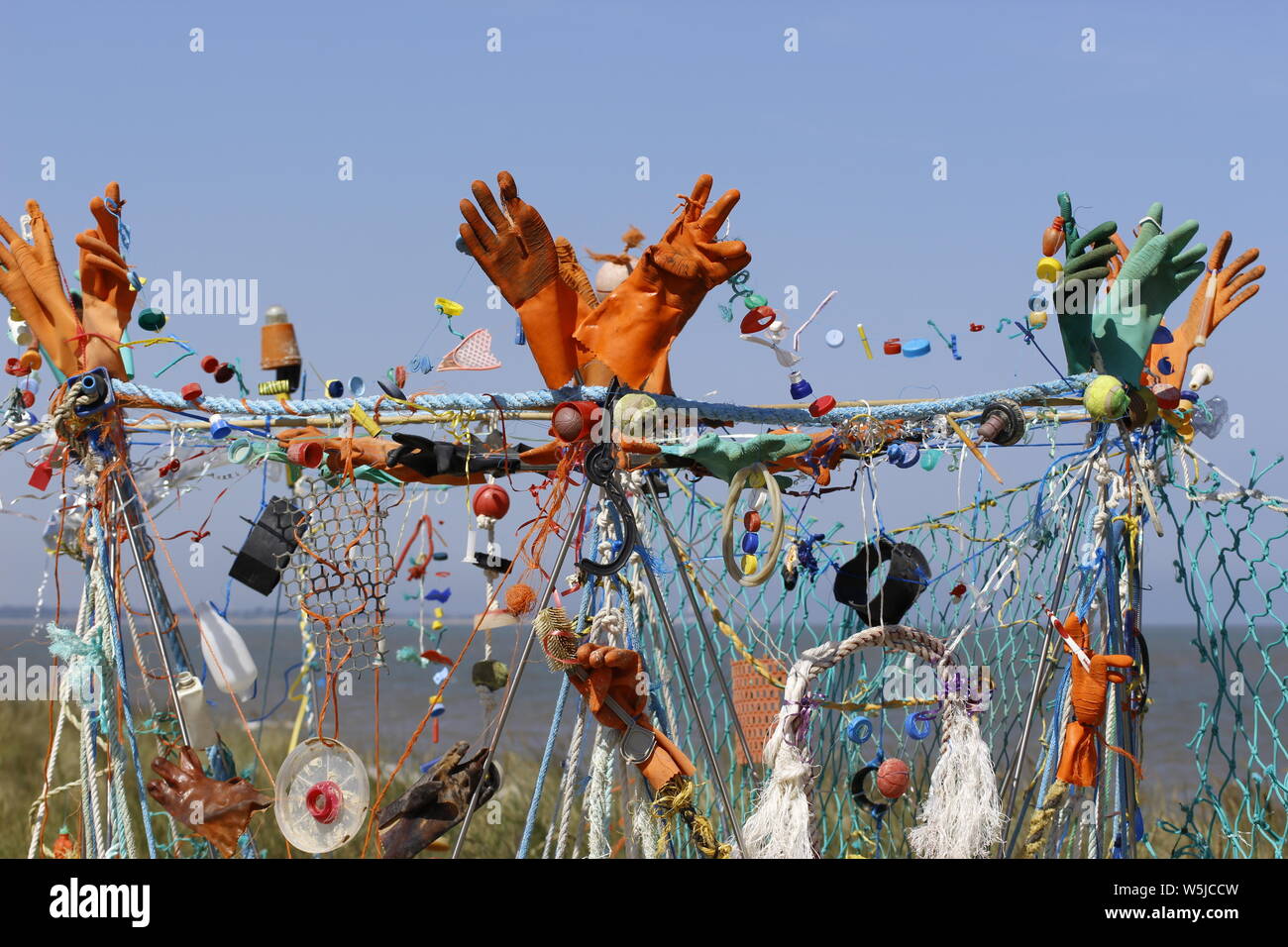 Varie voci di flotsam e jetsam lavato fino sulla riva del mare che sono stati raccolti e collocati in un disegno astratto Foto Stock