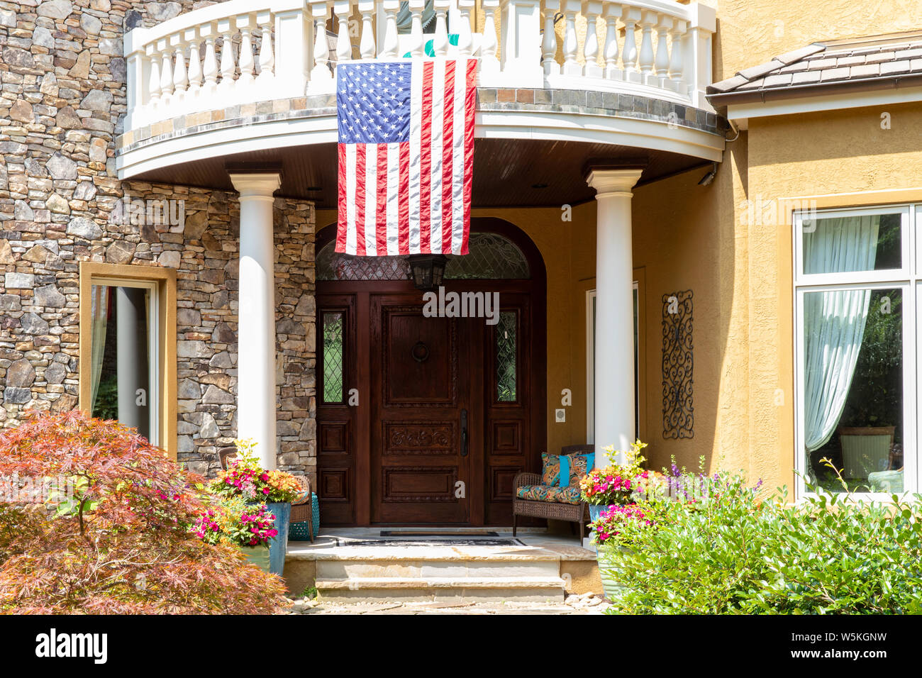 Bandiera americana appesa sopra la porta anteriore di una casa Foto Stock