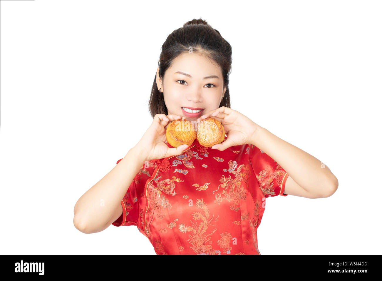 Bella donna cinese che indossa un Cheongsam o Chipao tenendo la torta della luna il cibo tradizionale della vacanza cinese di metà autunno Festival o isolato Foto Stock