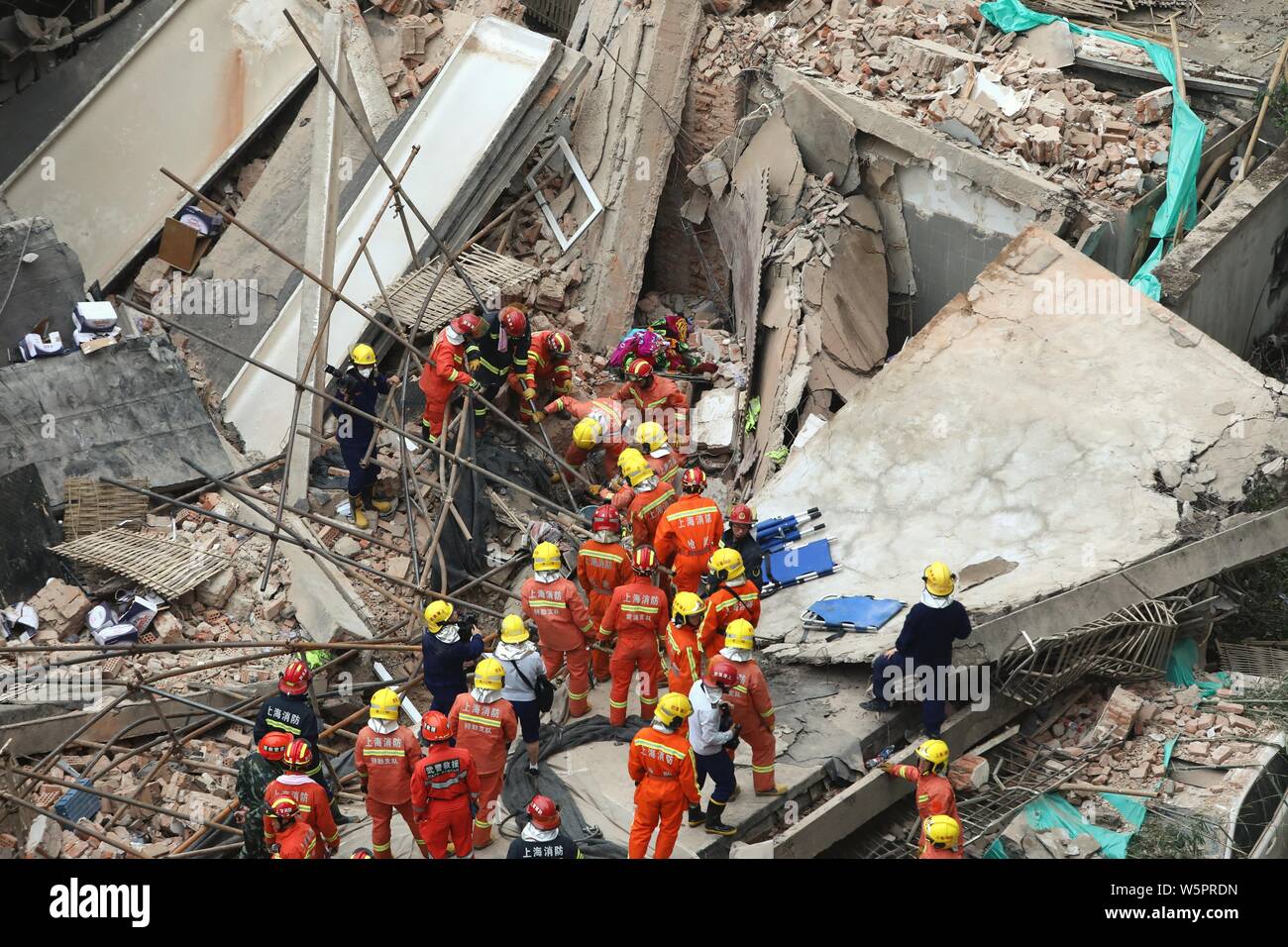 Il cinese Soccorritori alla ricerca di persone intrappolate nelle macerie del crollo di edificio in Cina a Shanghai, 16 maggio 2019. Dieci persone sono state uccise ed una Foto Stock