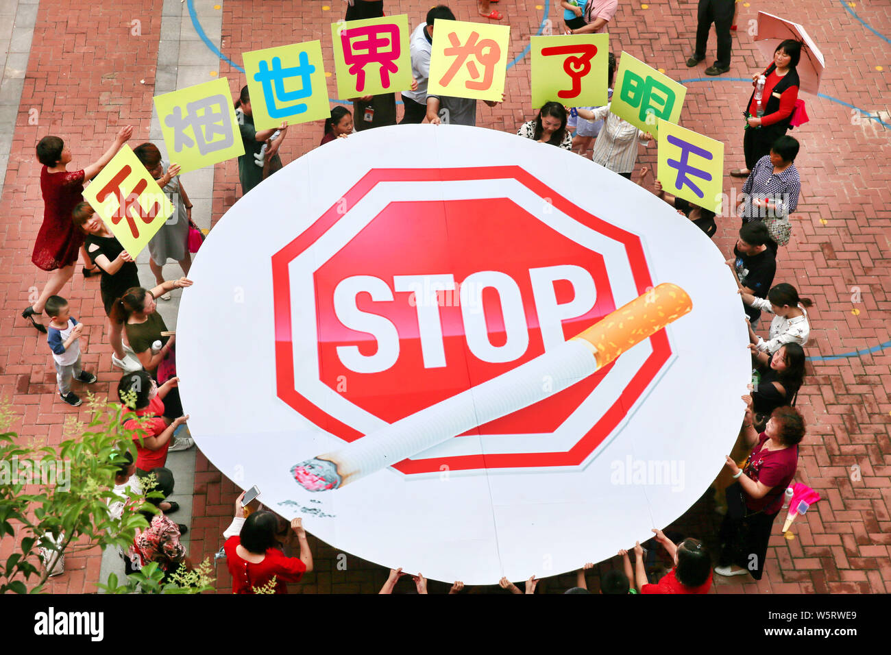 --FILE--cinese gli insegnanti e gli studenti di una scuola materna mostra un grande segno non fumatori per una campagna antifumo precedendo la celebra la Giornata Mondiale senza tabacco Foto Stock