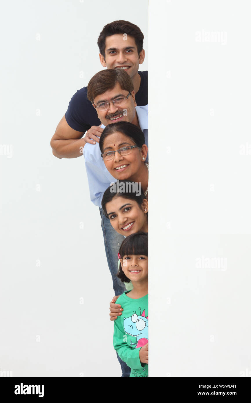 La famiglia si nasconde dietro un cartello Foto Stock