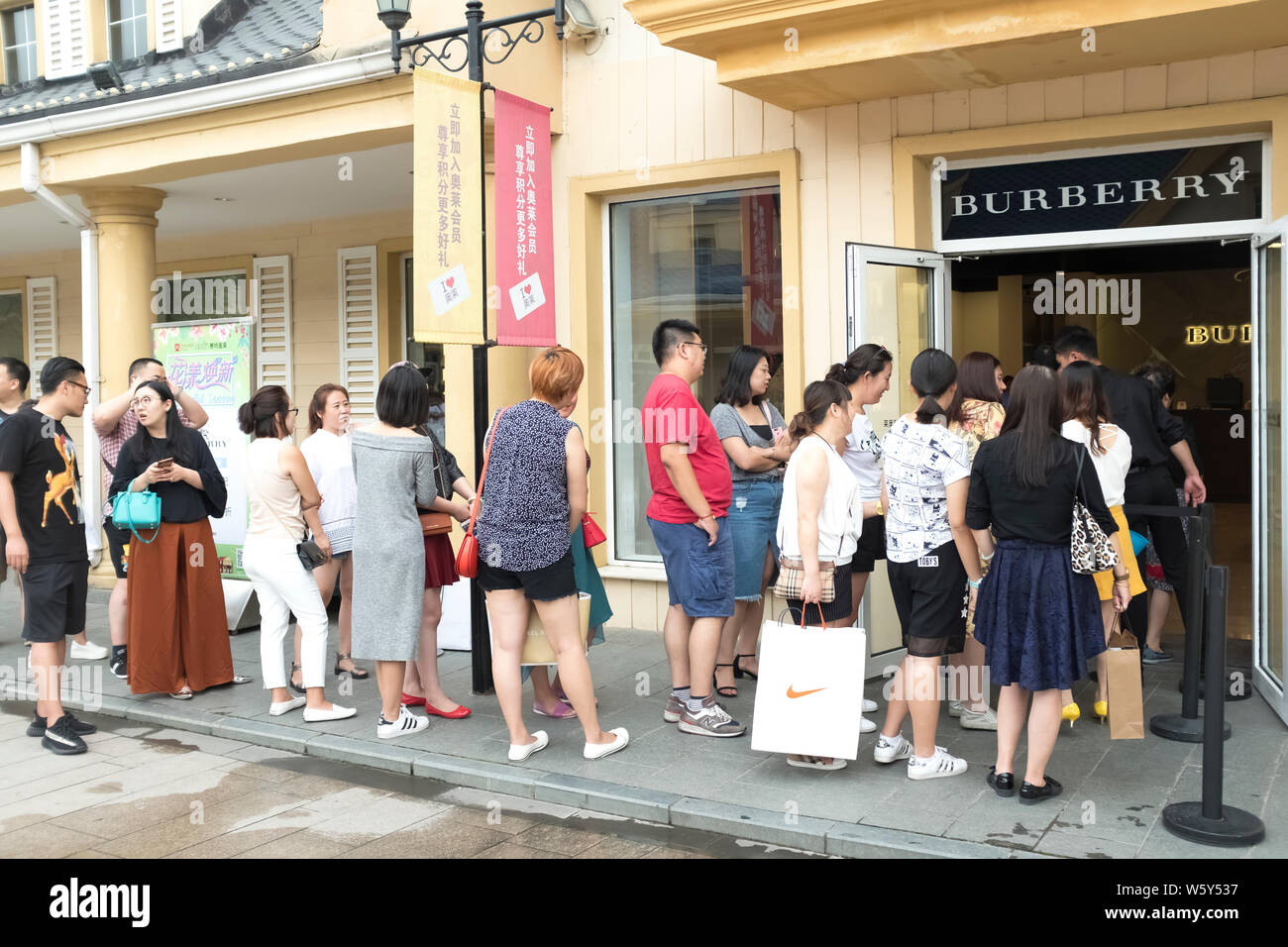 --FILE--i clienti attendono davanti a una boutique di Burberry a Pechino in Cina, 26 agosto 2017. British etichetta di lusso Burberry sta esaminando la possib Foto Stock