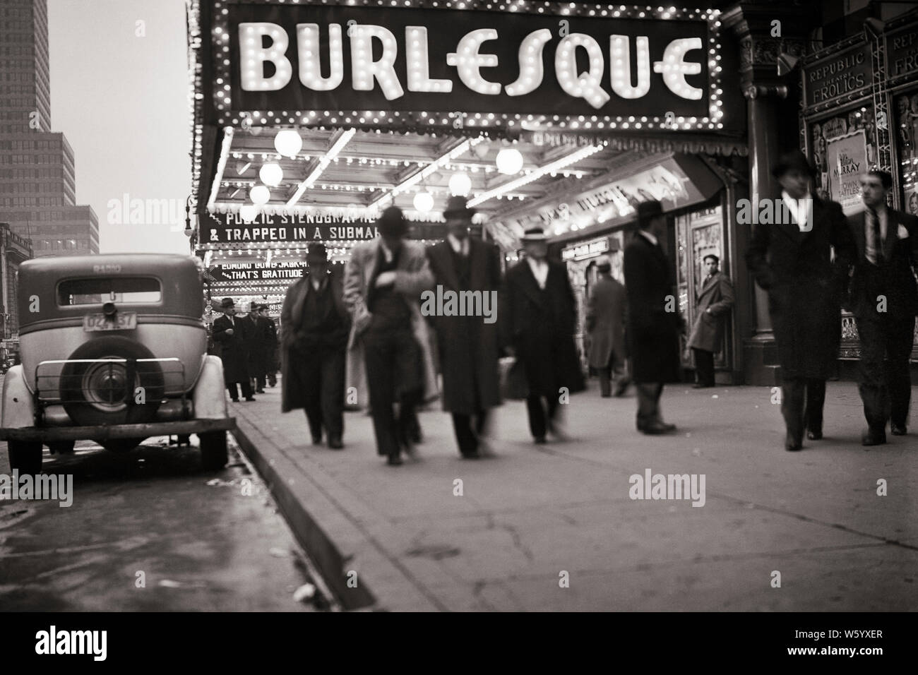 1930s 1933 pedoni gli uomini camminare sotto BURLESQUE MARQUEE ILLUMINATO SULLA WEST 42ND STREET MANHATTAN Theatre District New York STATI UNITI D'AMERICA - Q45950 CPC001 INTRATTENIMENTO HARS B&W NORD AMERICA LIBERTÀ NORTH AMERICAN successo performing arts tentazione indossare giacca e cravatta sogni luminosi forza di svago burlesco emozione ricreazione sui bulbi NYC NEW YORK città fuga elegante NEW YORK città passando da accesa a metà adulto metà uomo adulto i filetti 1933 in bianco e nero di etnia caucasica quartiere vecchio sordido Foto Stock