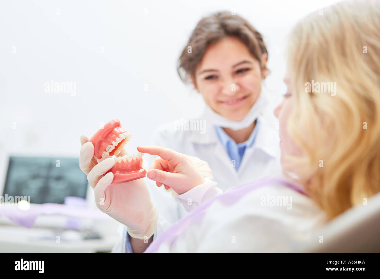 Dentista mostra bambino modello di dentiera durante un esame forense Foto Stock