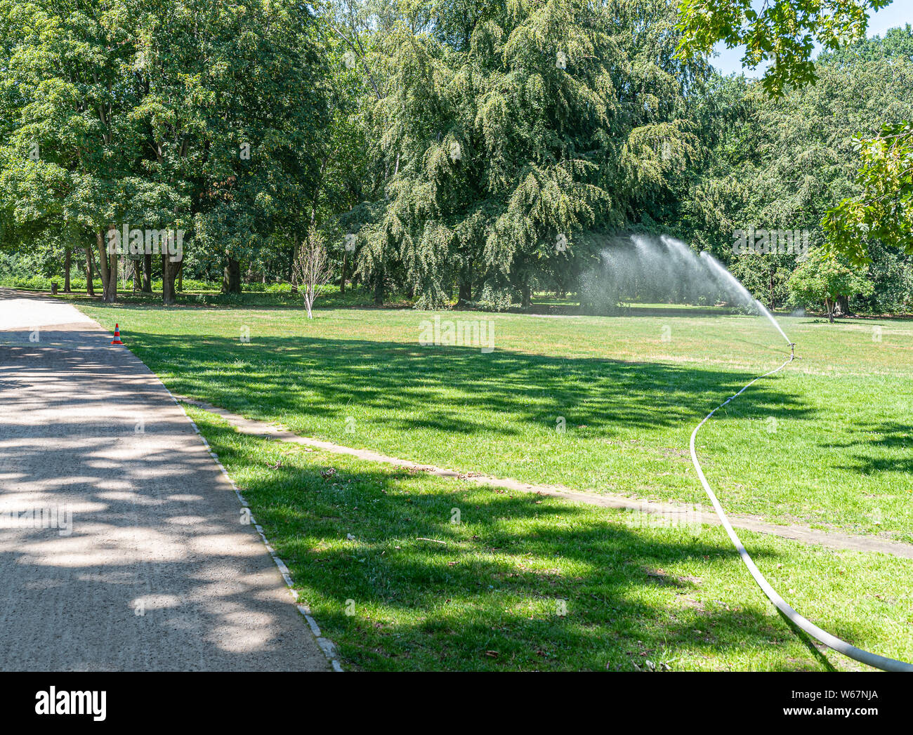 Sprinkler prato nel parco pubblico nelle calde giornate estive Foto Stock