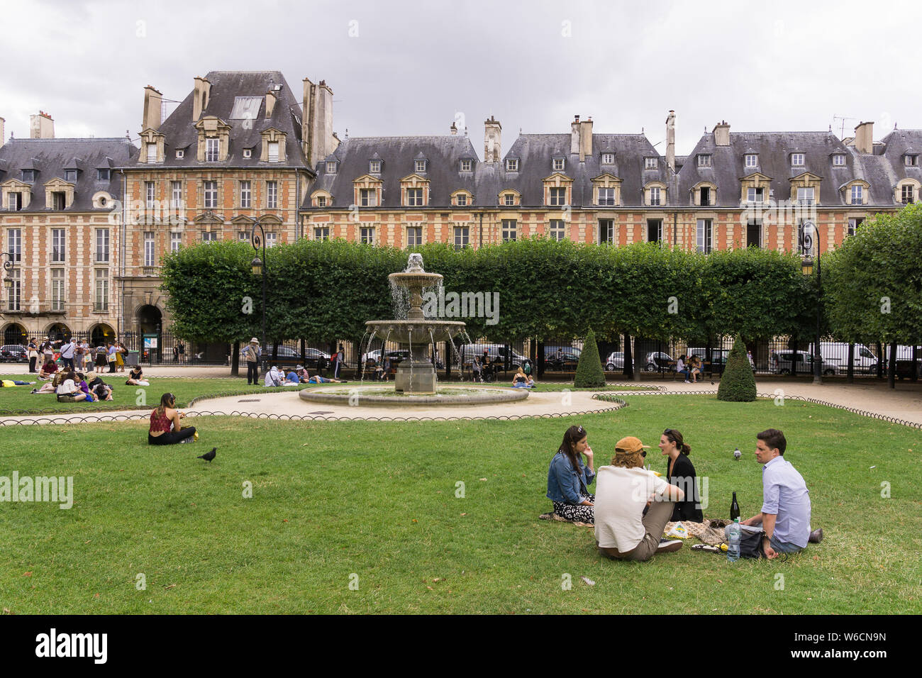 Parigi Place des Vosges - Vista di Place des Vosges e uno dei suoi quattro fontane situato nel quartiere Marais di Parigi, in Francia, in Europa. Foto Stock