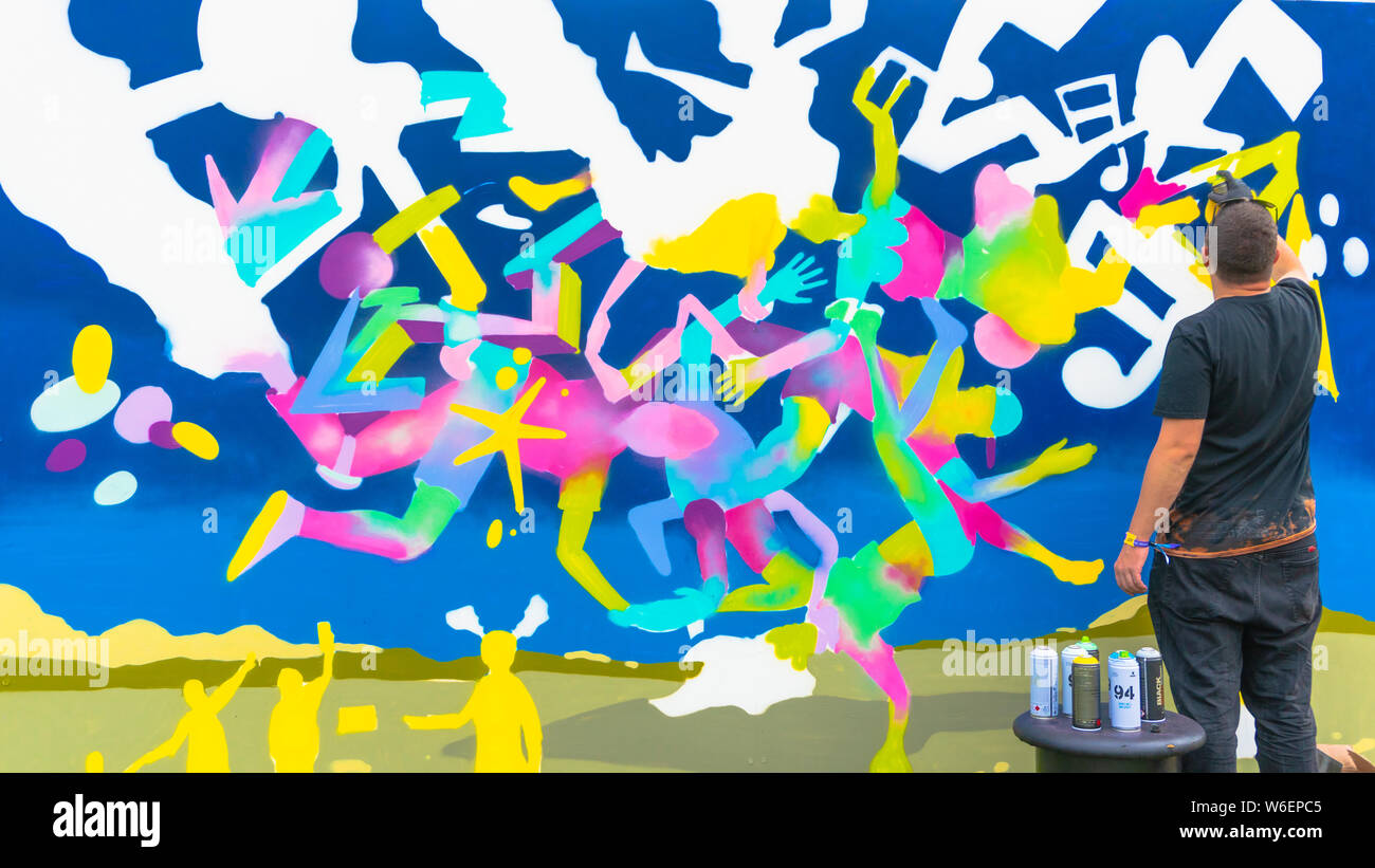Il giovane disegno con spray - artista di graffiti pittura con aerosol  bombolette di colore sulla parete. Arte di strada. Abstract immagine di  sfondo di graffiti Foto stock - Alamy
