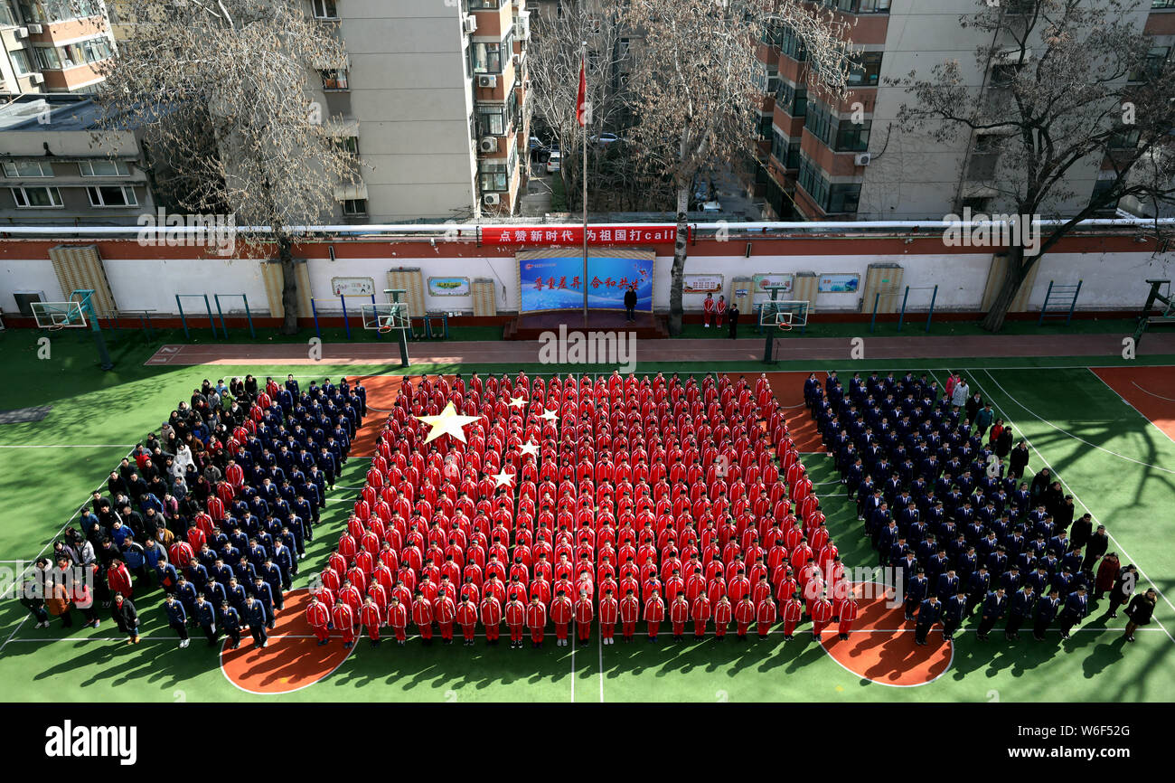 Vista aerea del 384 gli studenti delle scuole medie vestito di rosso formando una formazione nella forma della bandiera nazionale cinese il primo giorno di scuola in J Foto Stock