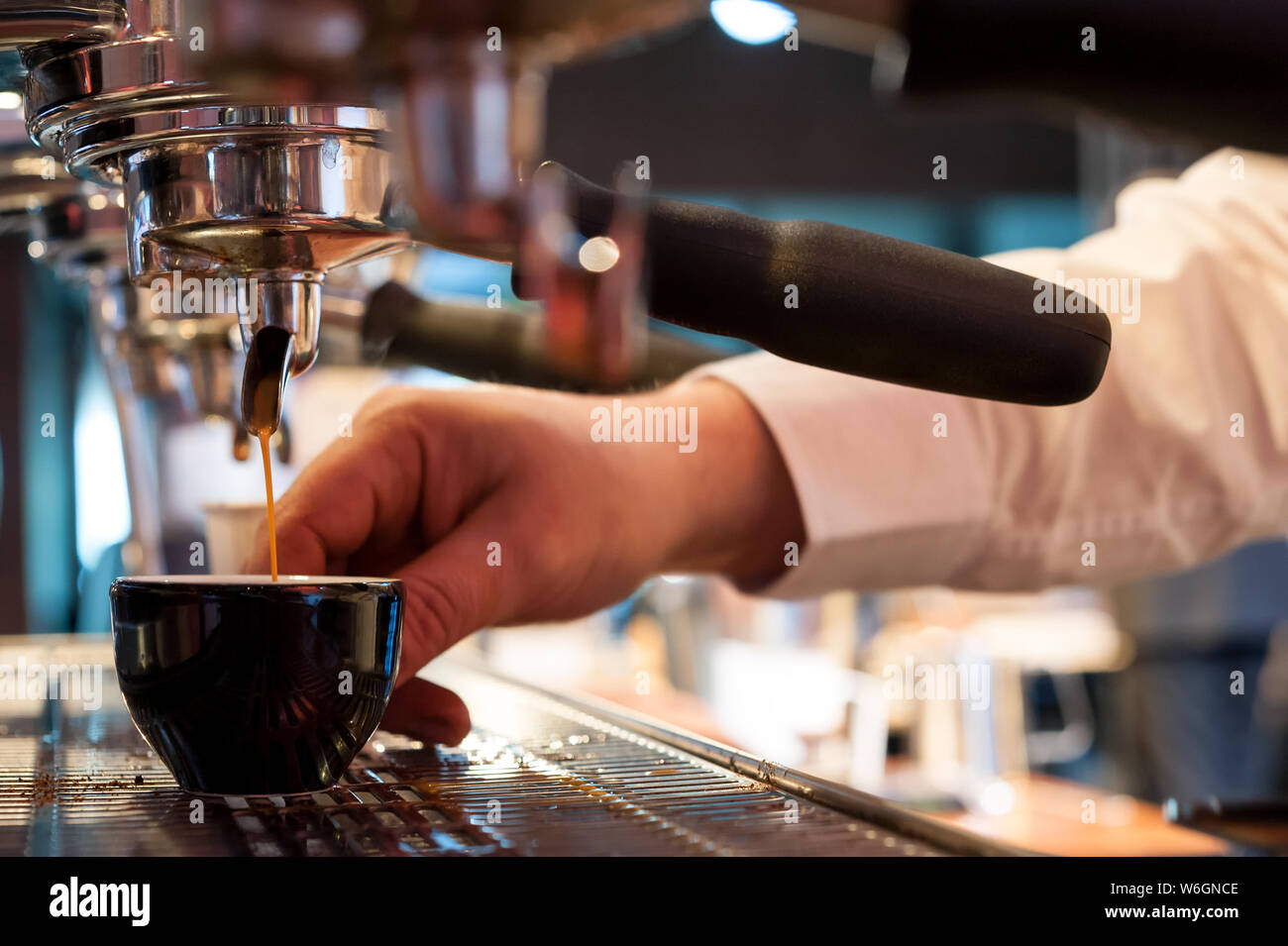 La preparazione di italiano del caffè fresco presso la macchina per espresso professionale Foto Stock