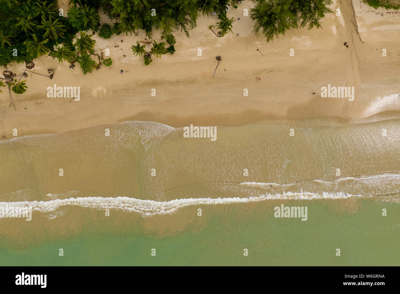 Vista aerea di onde che si infrangono su un vuoto, sabbiosa spiaggia tropicale Foto Stock