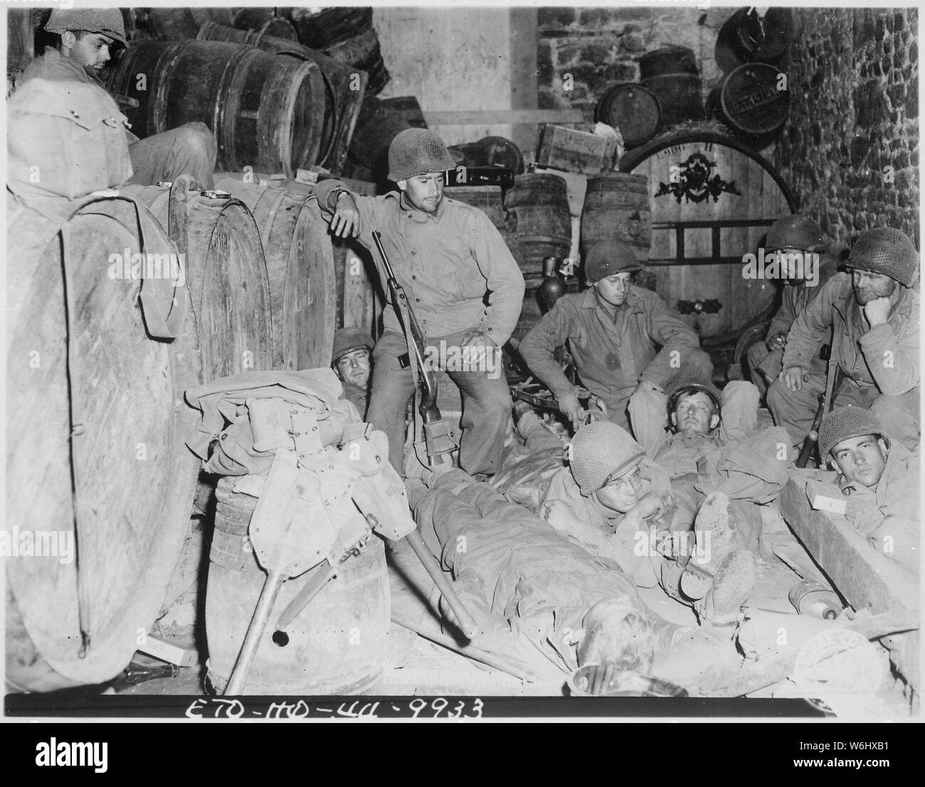 Fanti prendere un breve riposo prima di spinta sul, in una casa abbandonata nella cittadina francese di Tessy sur Vire. Il nostro 'foxhole' per la notte era una cantina di birra. Vi erano beaucoup fusti verso il basso ma era vuota. Il ragazzo, eravamo tristi sacchi.; Note Generali: Utilizzo di guerra e di conflitto numero 1048 quando si ordina una riproduzione o la richiesta di informazioni su questa immagine. Foto Stock