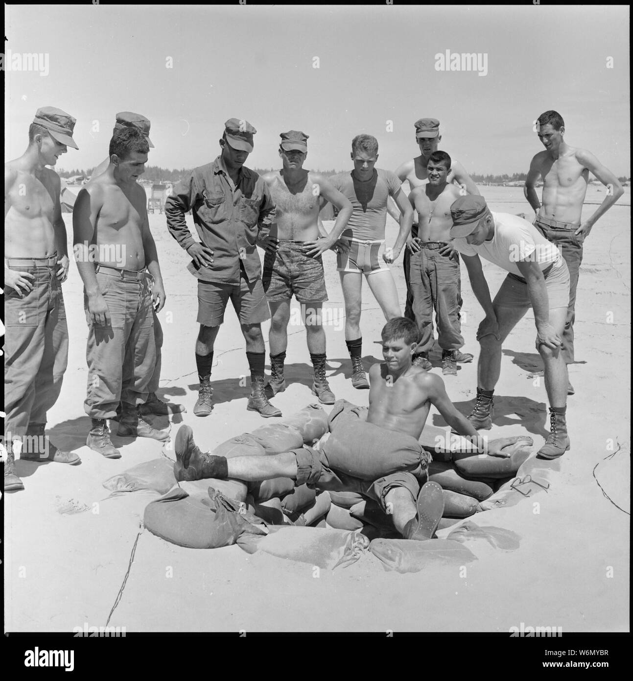 Il Vietnam....Primo Tenente Jay Robertson incarica privato di prima classe CECIL E. Dorsey in una schiena, gambe e stomaco esercizio muscolare al 2 ° Battaglione, 7 Marines, area. Foto Stock
