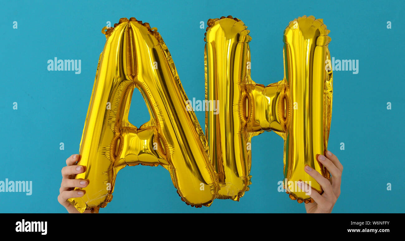 Golden AH parola fatta di palloncini gonfiabili Foto Stock