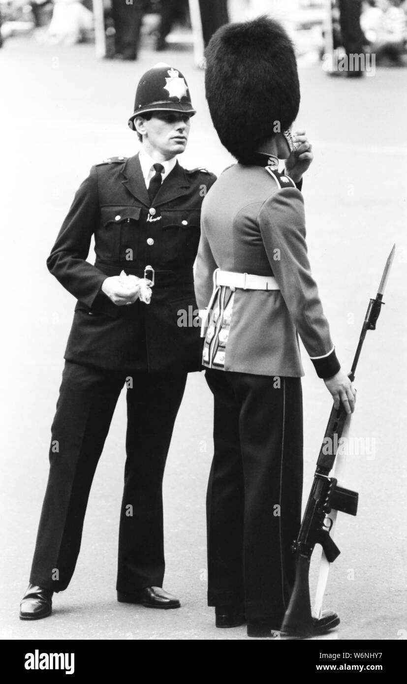 Ufficio di polizia alimenta un dolce bollita per un guardsman in servizio presso il Royal Wedding del principe Charles e Lady Diana Spencer per aiutare a proteggersi contro svenimento attraverso bassi livelli di zucchero. Foto Stock