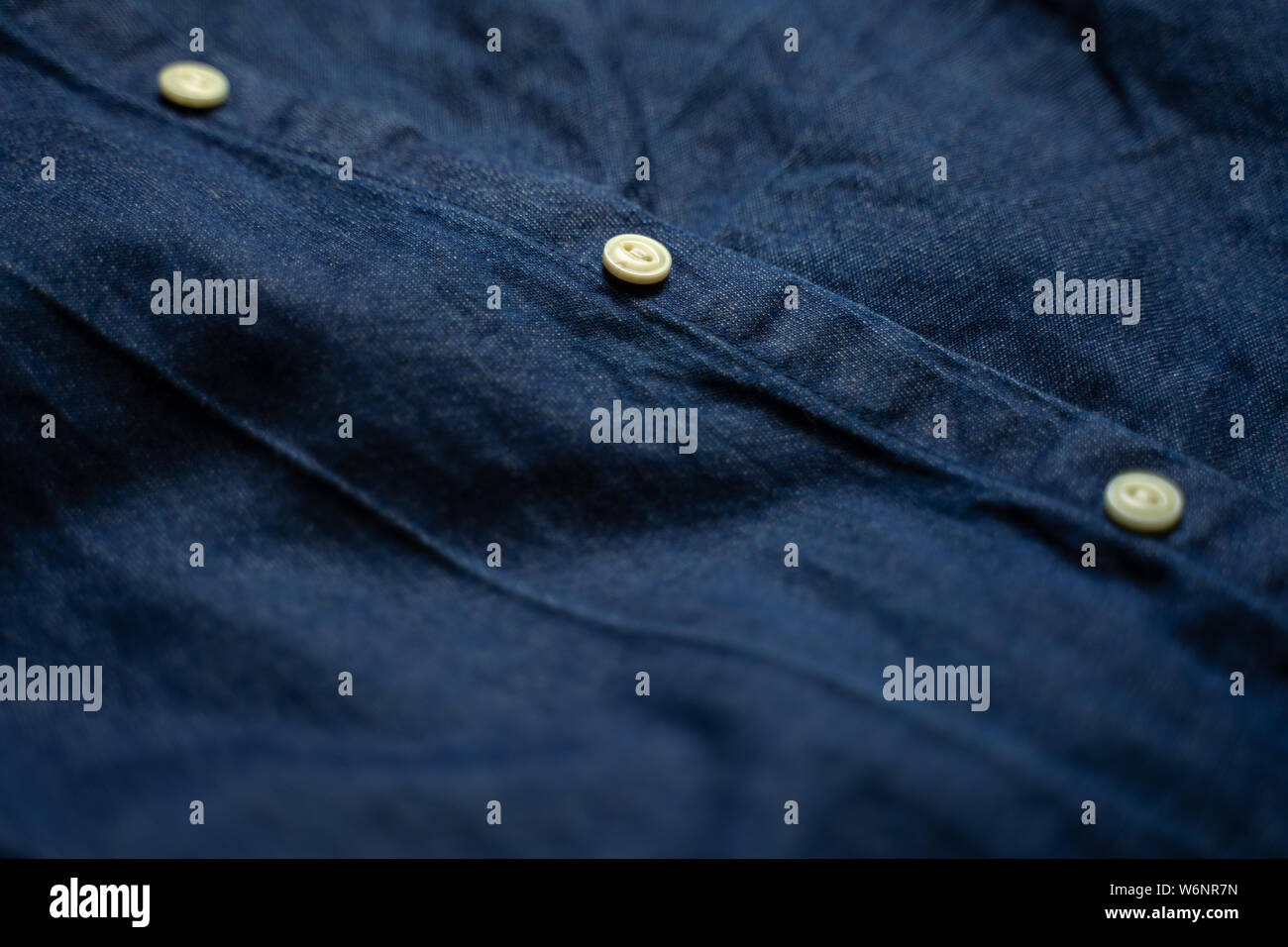 Blu Denim shirt con pulsanti bianchi close-up. Sfondo di indumento Foto Stock