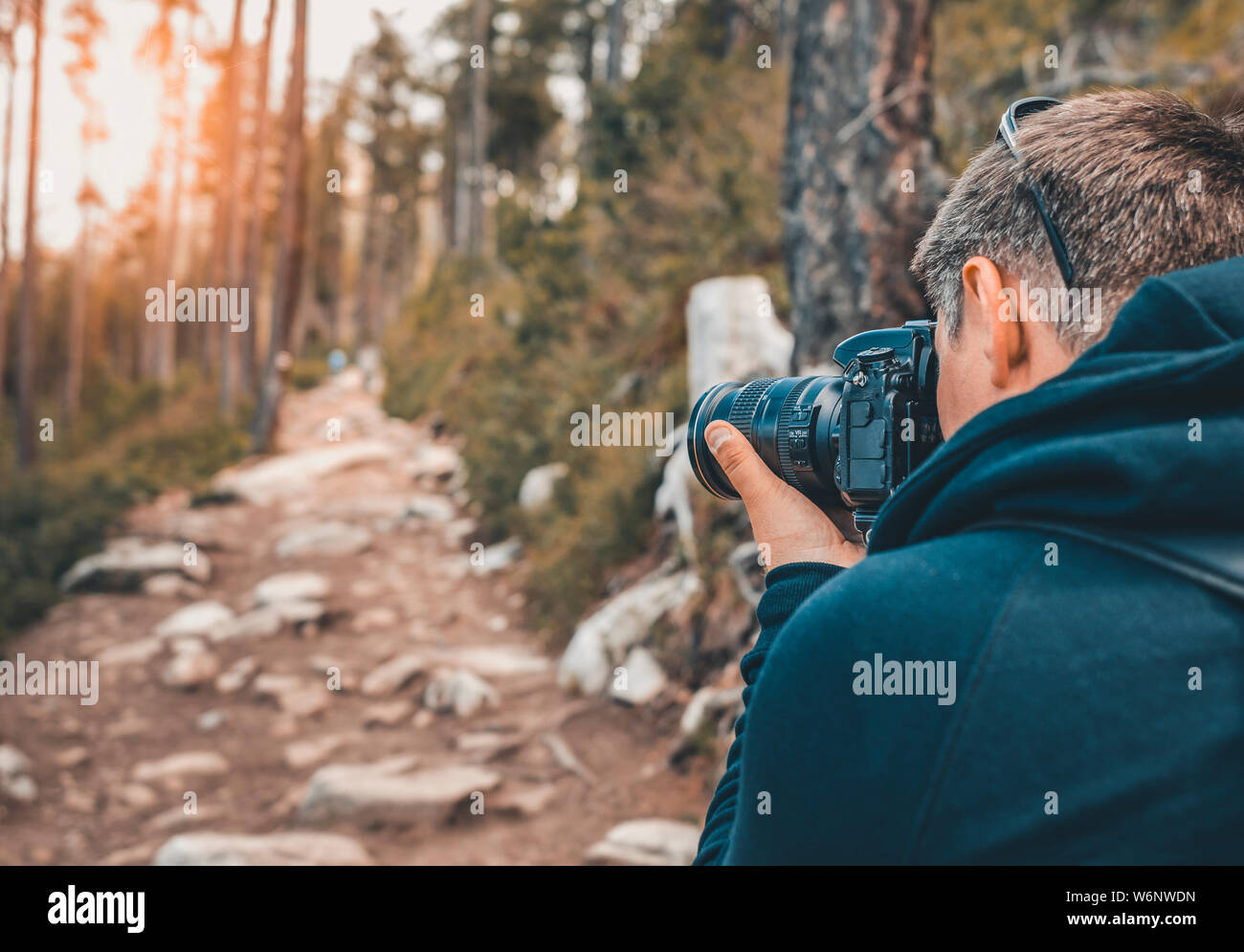 Fotografo uomo con una telecamera in una foresta. Foto Stock