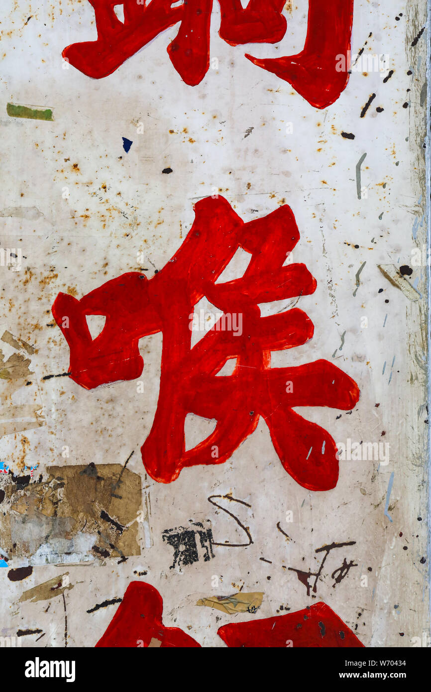 I caratteri cinesi scritte sul muro con la vernice rossa in Mong Kok, Hong Kong Foto Stock