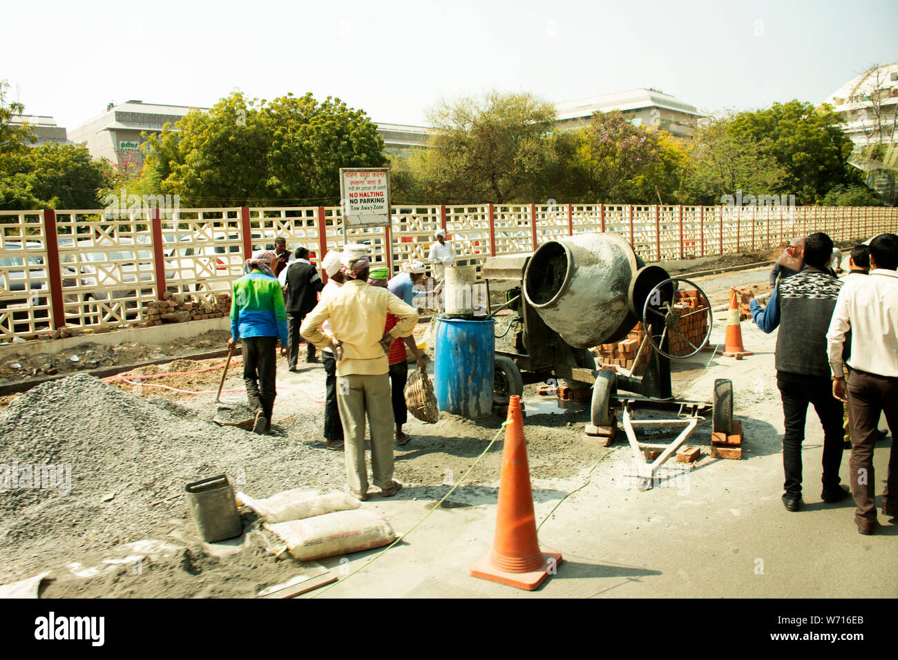 Popoli asiatici e lavoratori indiani con macchinari pesanti di generatore di lavoro nuovo sentiero al sito in costruzione accanto alla strada a Delhi city il 18 marzo 2019 in Foto Stock