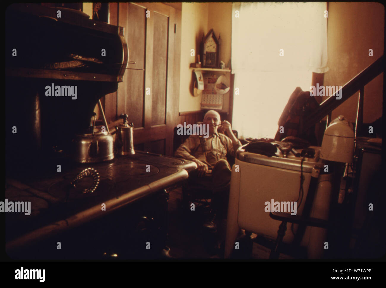 Un 80-anno-vecchio nativo di East Randolph, Vermont, si siede di nuovo nel suo angolo preferito VICINO AL CALORE DEL WOODSTOVE a prendere la sua metà giornata di riposo Foto Stock