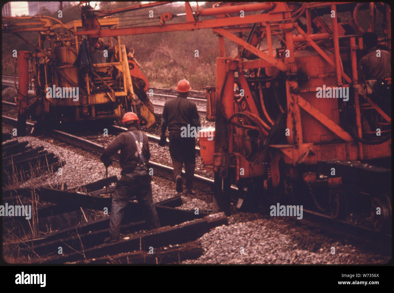 Stazione ferroviaria meridionale a lavoratori e macchinari. La macchina martinetti fino le rotaie, tira fuori la vecchia di traverse e luoghi nuovi, TAMPS i legami in posizione, quindi i picchi di unità per tenere le guide in posizione. La società ha speso il 18,6 per cento delle sue entrate nel 1974 SULLA VIA DI MANUTENZIONE. Che anno sud aveva una media di quattro equipaggi di 50 a 55 uomini ciascuna lavorando sul sistema di 10,531 chilometri di pista Foto Stock