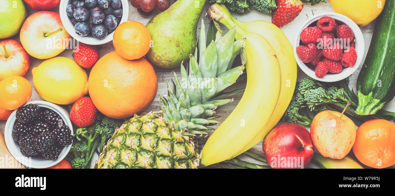 Sani frutti ortaggi riempito di sfondo con Fragole Lamponi arance Prugne Mele Kiwi uva broccoli cauiliflower mango pino persimmon Foto Stock