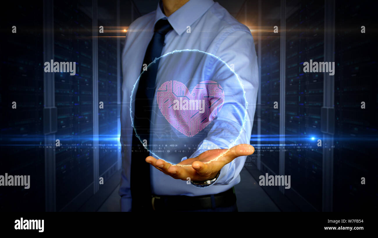 Uomo con cibernetico dinamico il simbolo del cuore di ologramma su mano. Imprenditore e futuristico concetto di amore, cyber dating, romantico, salute, scienza e auto Foto Stock