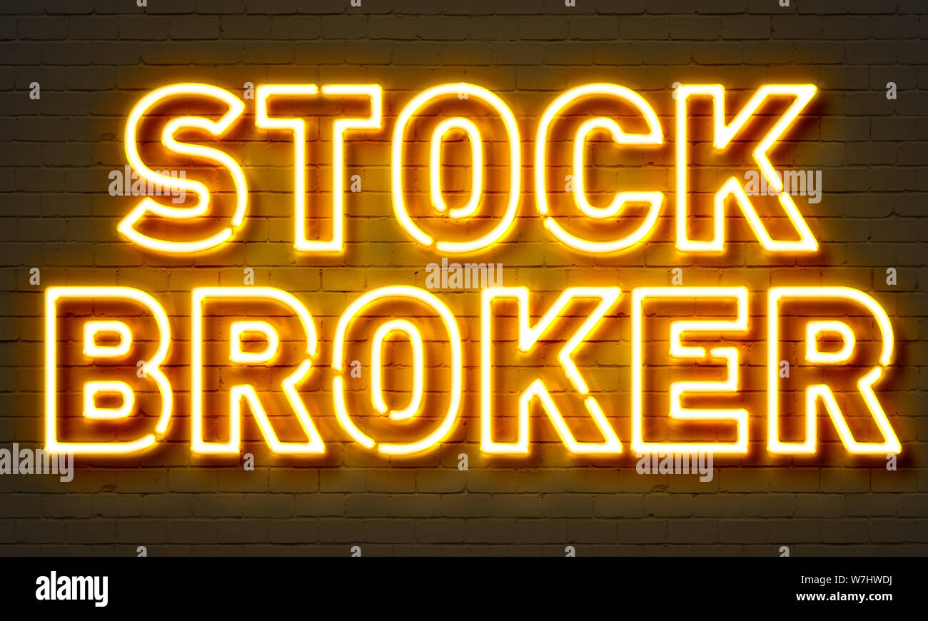 Stock broker segno al neon sul muro di mattoni in background Foto Stock