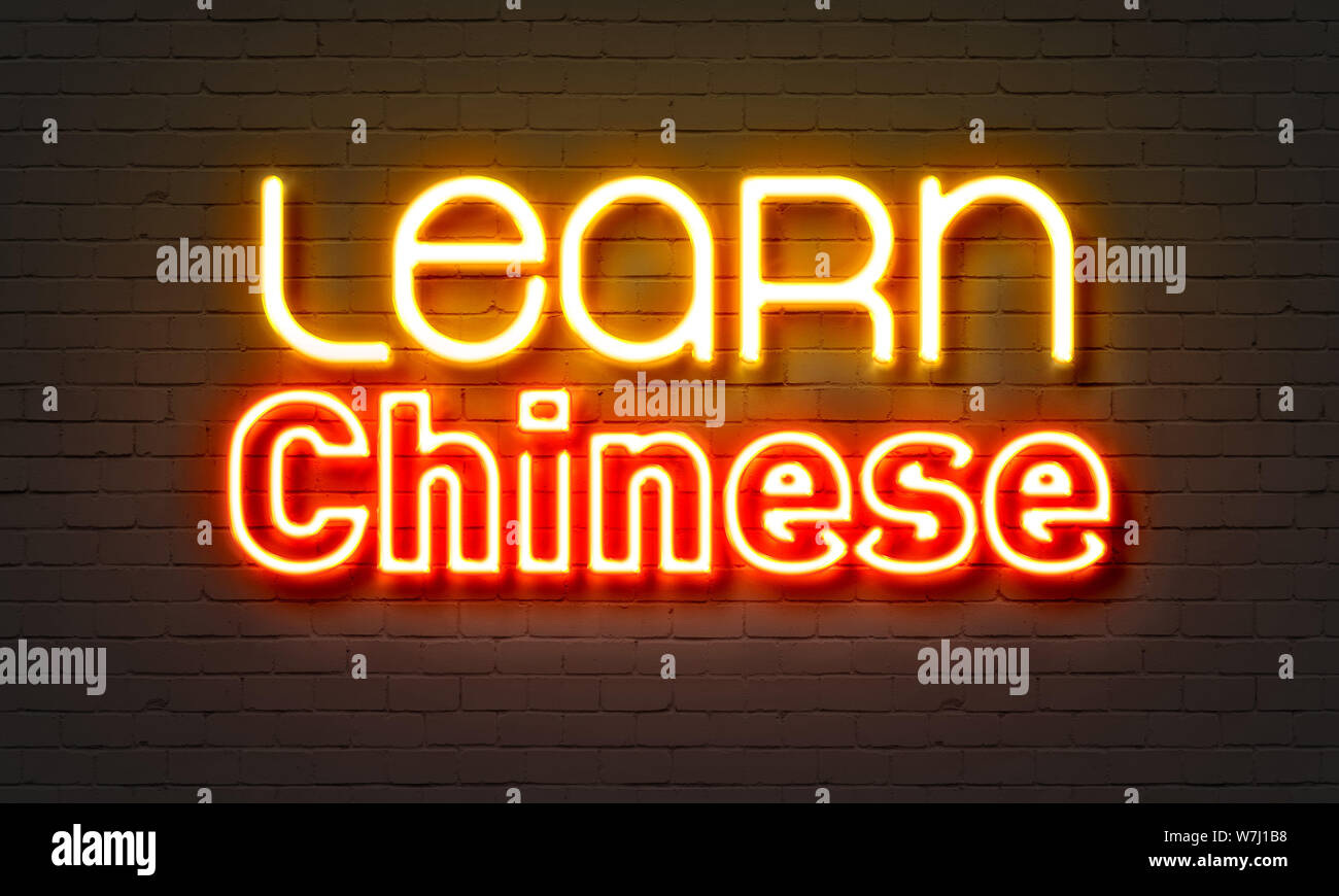 Impara il cinese insegna al neon sul muro di mattoni in background Foto Stock