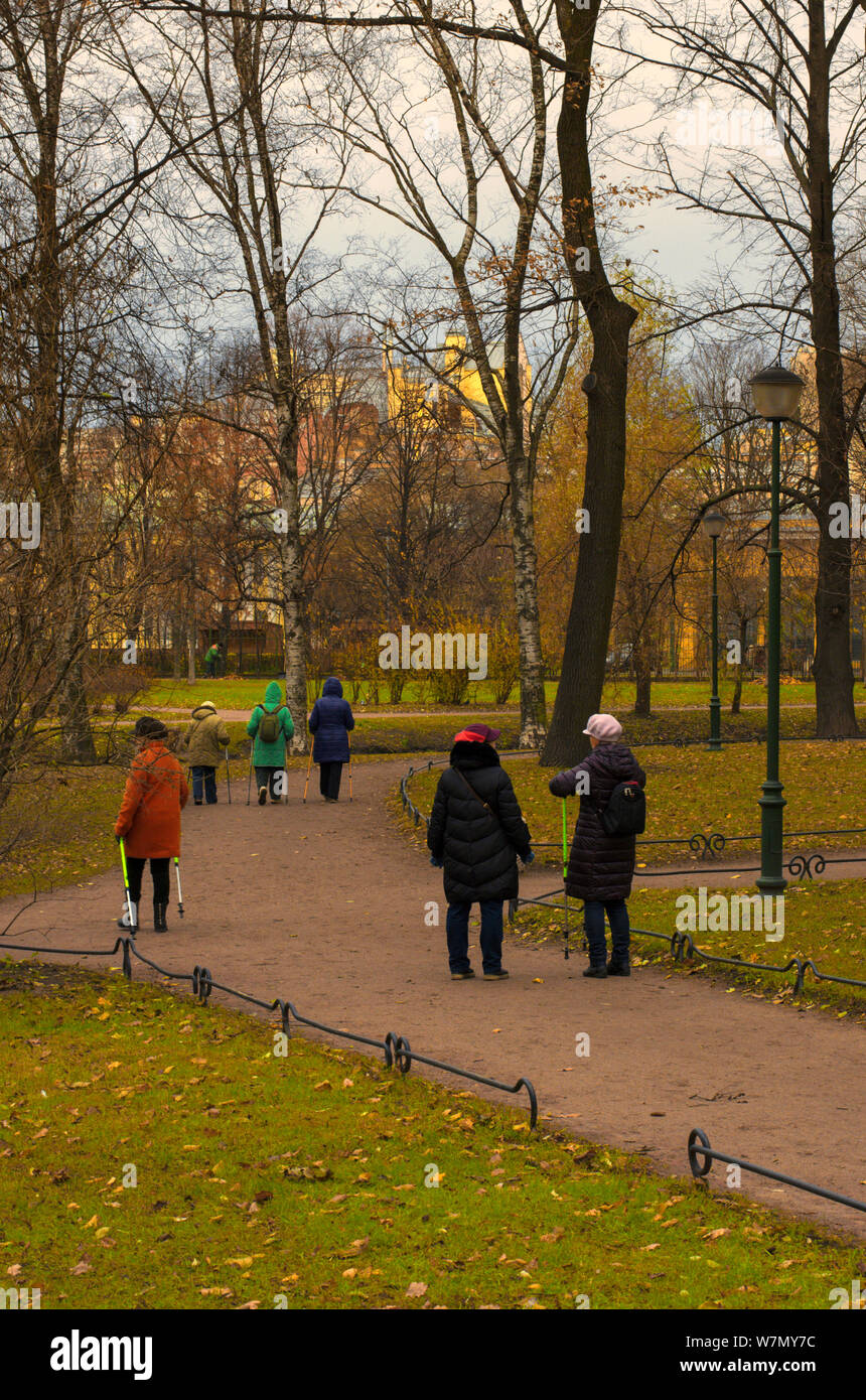 Saint Petersburg, Russia - 16 Novembre 2018: gli anziani impegnati in Nordic walking nel parco in un giorno nuvoloso nel tardo autunno Foto Stock