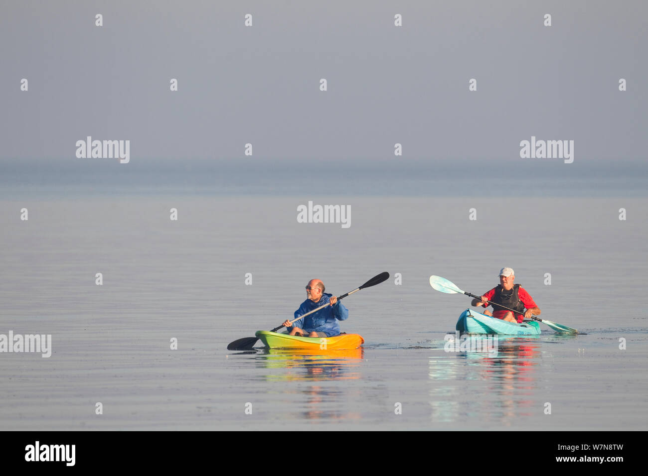 Due persone fare kayak all'alba. L'estuario del lavaggio, Norfolk, Settembre. Foto Stock