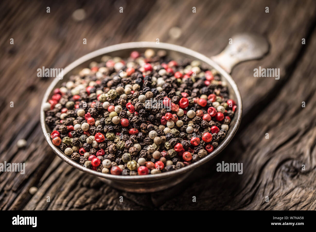 Grani di pepe misto rosso nero e bianco nella ciotola - Close-up Foto Stock