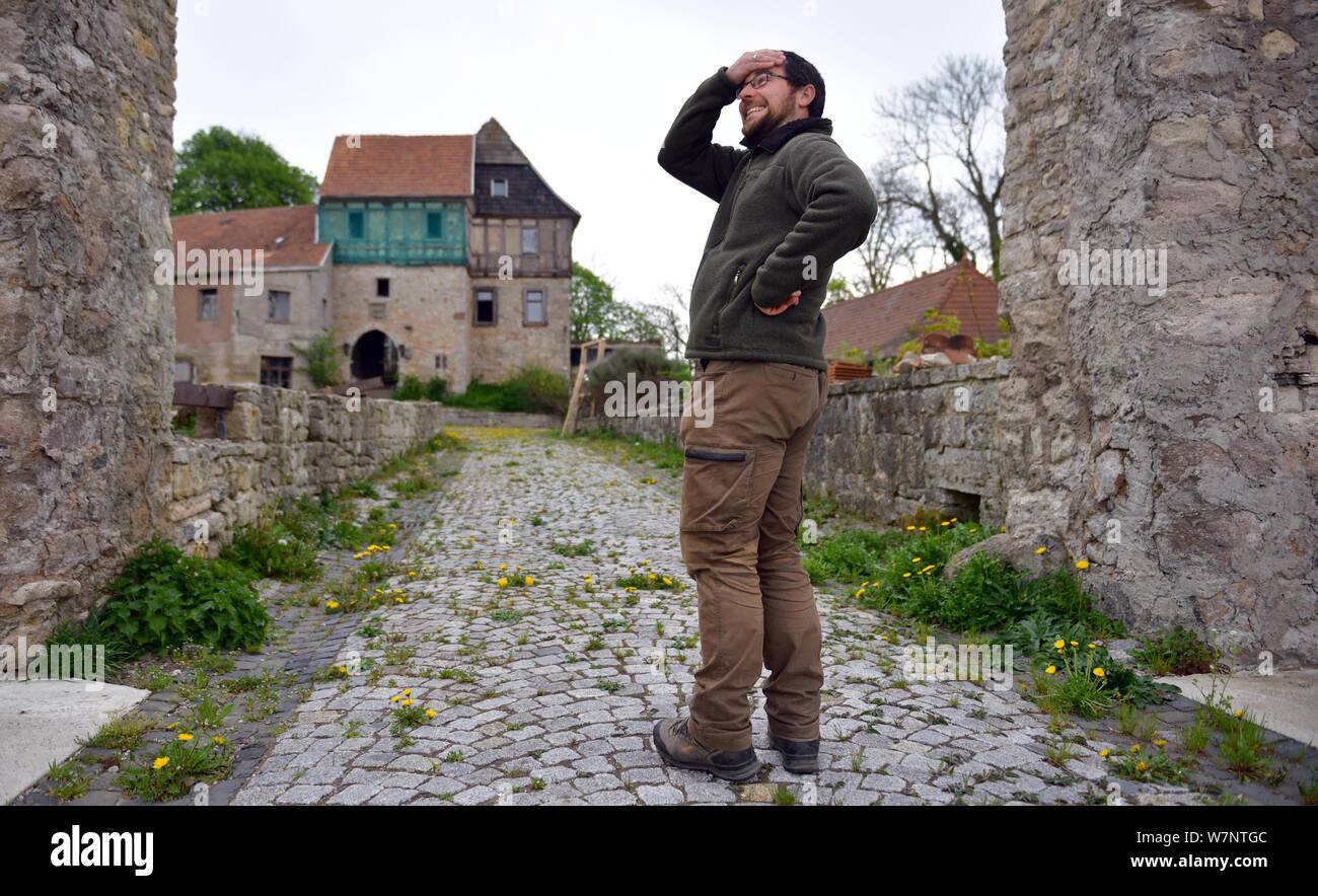 Wachstedt, Germania. 26 apr, 2019. Christoph Weidner, signore del castello, ambientale pedagogo e automotive tecnico meccatronica, sorge di fronte al 800-anno-vecchio castello Gleichenstein nell'Eichsfeld nel nord della Turingia. Il 35-anno-vecchio figlio di un sacerdote che affonda le sue radici nella parte orientale della Turingia ha acquisito il male il castello danneggiato lo scorso anno al fine di salvare e rilanciare. Lui è la pianificazione di un luogo per celebrare e un programma di utilità di canapa fabbrica di schiuma. Un piccolo museo è anche quello di essere costruito. Credito: Martin Schutt/dpa-Zentralbild/ZB/dpa/Alamy Live News Foto Stock