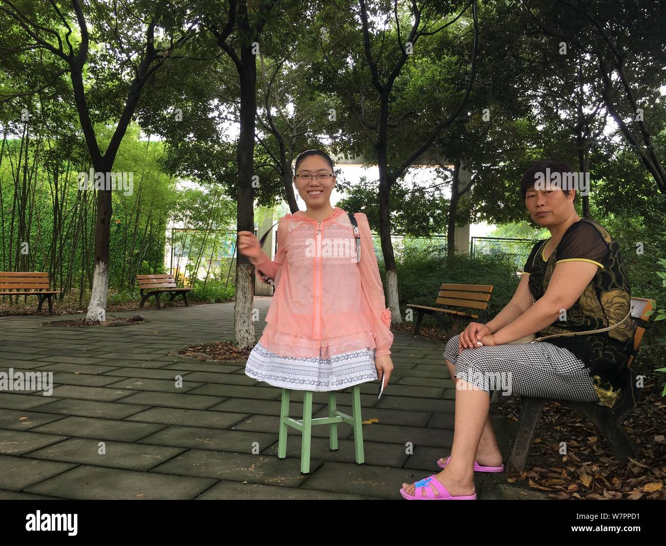 Cinese strumento "girl' Huang Huan è raffigurato con la sua madre su uno sgabello dopo assunzione orale del test di inglese del 2017 Collegio Nazionale Examin ingresso Foto Stock