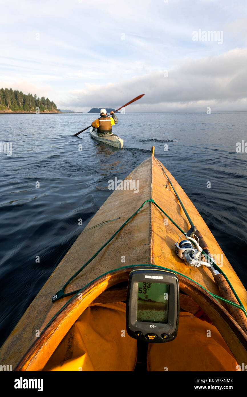 Vista dal kayak come Phil Russell apre la strada ai fondali di pesca lungo lo stretto di Juan De Fuca, Washington, USA, Agosto 2014. Modello rilasciato. Foto Stock