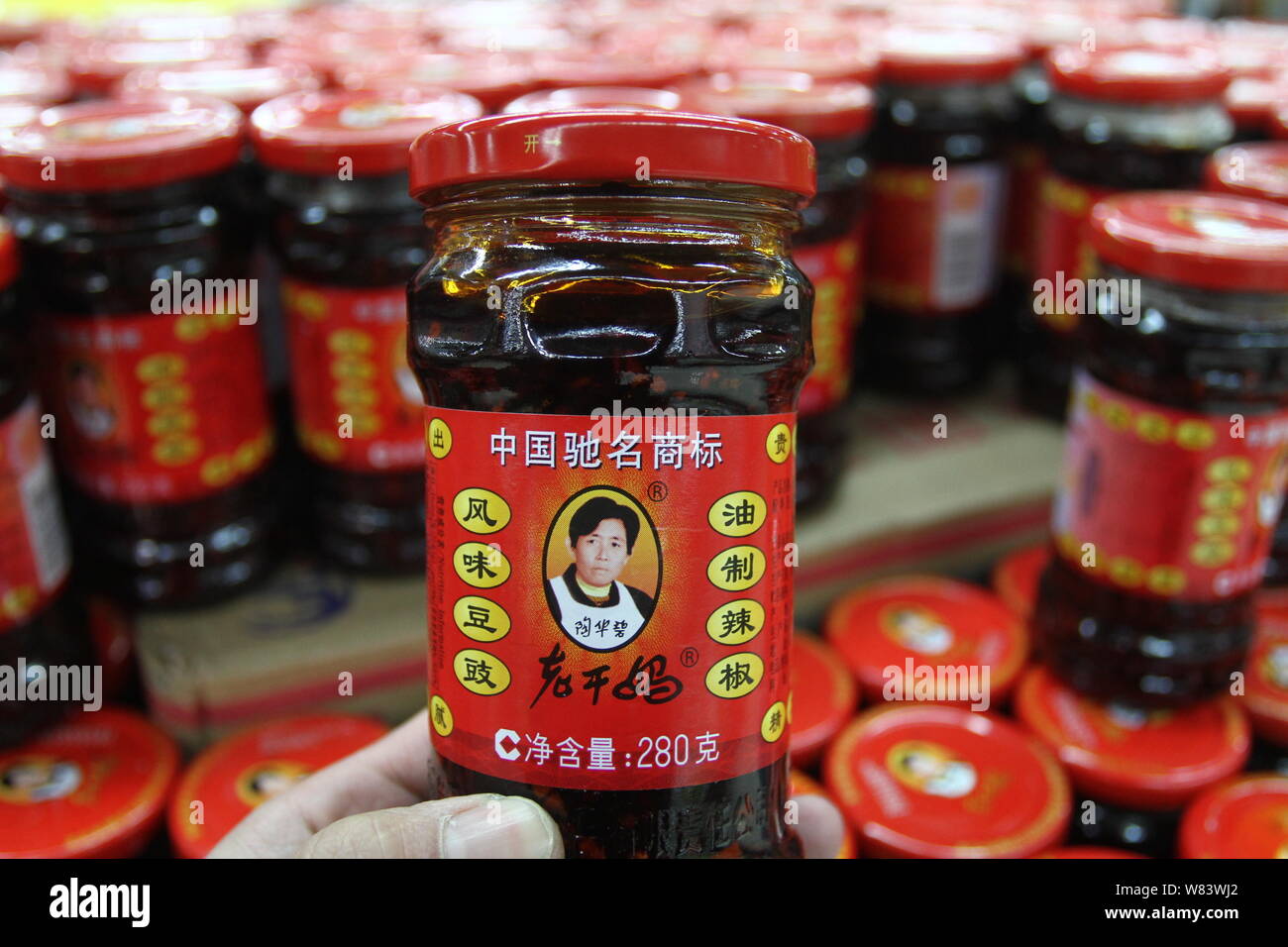 --FILE--un acquirente acquista una bottiglia di Lao Gan Ma o Laoganma salsa chili in un supermercato in città Xuchang, centrale cinese della provincia di Henan, 8 febbraio 201 Foto Stock