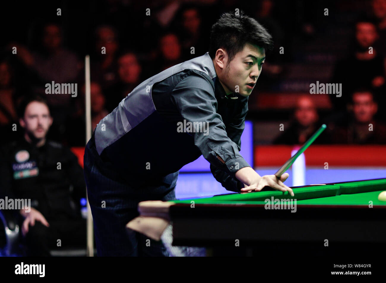Liang Wenbo della Cina ritiene un colpo contro Judd Trump di Inghilterra in loro corrispondenza finale durante l'inglese Open 2016 torneo di biliardo in Manchester Foto Stock