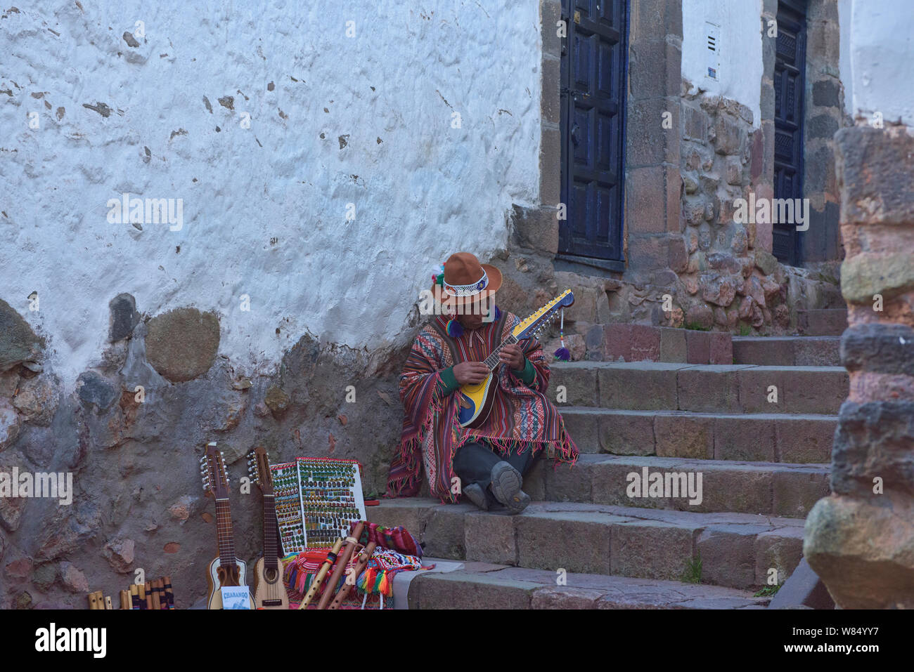 Musicista andina a giocare il suo charango sulle stradine della città di Cusco, Perù Foto Stock