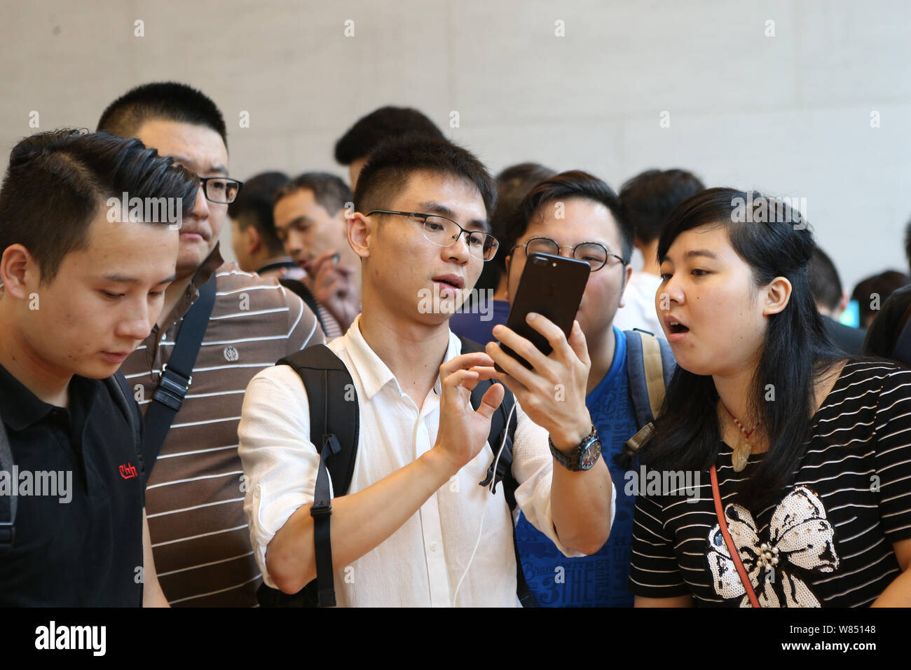 Un cliente tenta di eseguire un iPhone 7 più smartphone a un Apple Store in Cina a Shanghai, 16 settembre 2016. Apple Inc fan da Sydney a Shanghai, il Foto Stock