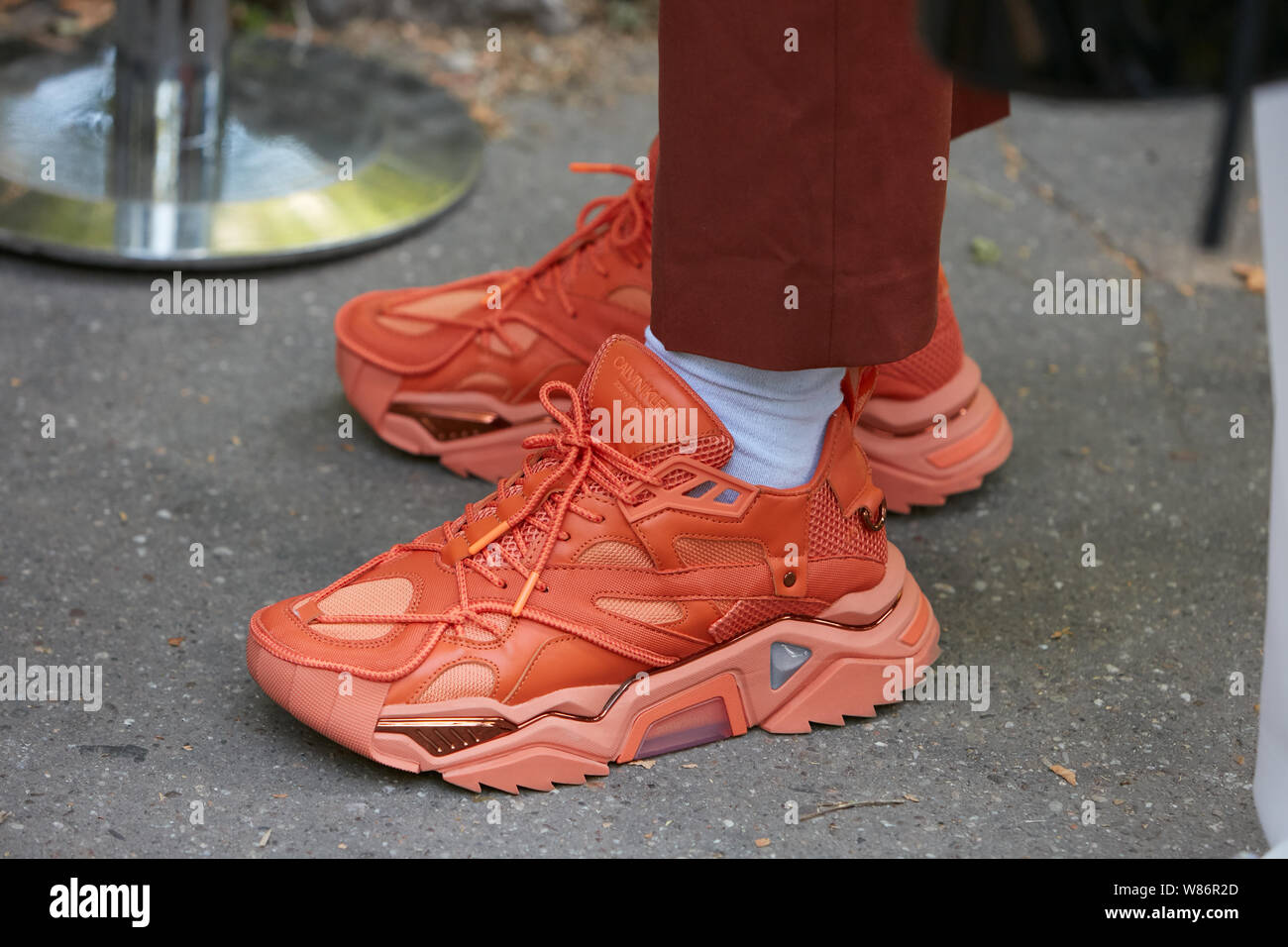 Milano, Italia - 17 giugno 2019: l'uomo con orange Calvin Klein sneakers prima di Fendi fashion show, la Settimana della Moda Milanese street style Foto Stock