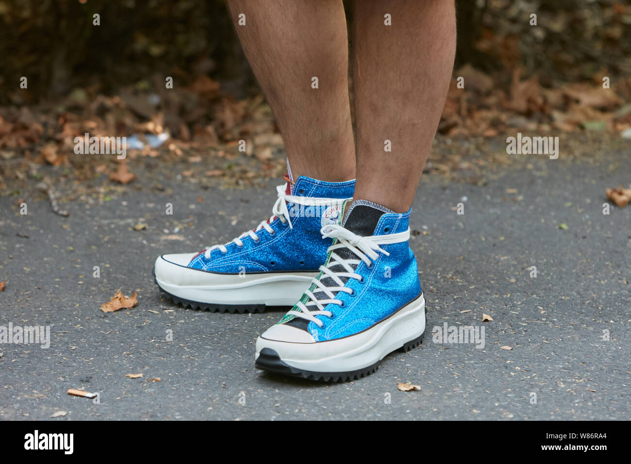 Milano, Italia - 17 giugno 2019: Uomo con Converse blu glitter sneakers prima di Fendi fashion show, la Settimana della Moda Milanese street style Foto Stock