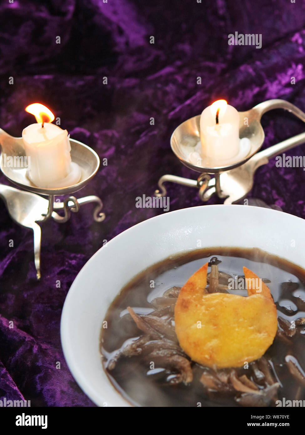 Dolcetto o scherzetto halloween della strega. Zuppa zuppa di cipolle francese con parmigiano croccante nella forma del diavolo corna. Foto Stock